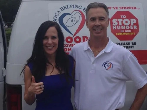 Two people posing together at a charity event for Statler Orthodontics food drive fundraiser.