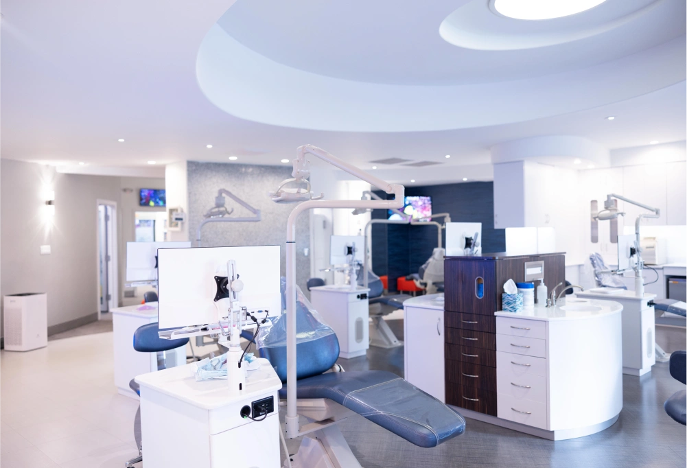Modern orthodontic dental office with advanced equipment and blue accent furniture in clean, bright interior.